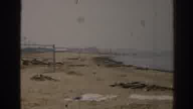 New Jersey USA (1963): Couple Standing On Seashore And Man In The Water On