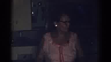 New Jersey USA (1963): Woman In Pink Dress Talks And Walks In Kitchen Of A House