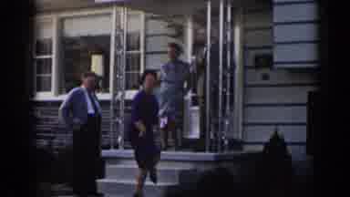New Jersey USA (1963): Two Women Dancing Outside Of A House As A Man Looks On A