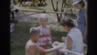 New Jersey USA (1963): Man Watches Woman And Children In The Garden In The Morning