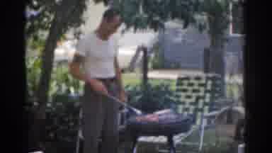 New Jersey USA (1963): Dad Grilling Chicken And Beef For His Family On A Hot Sunny