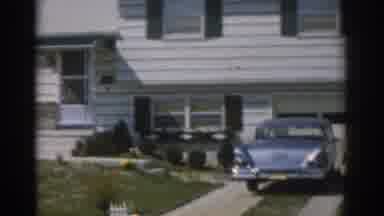 New Jersey USA (1963): An Older Woman Wearing A Dress Walks Around A House During