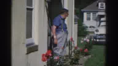 New Jersey USA (1963): Man Surveying Garden With Roses A Parked Car And A Deck