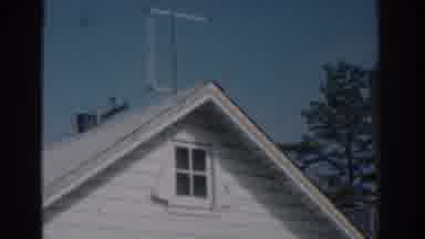 New Jersey USA (1963): View Of TV Antenna On Roof Of A White House And Woman
