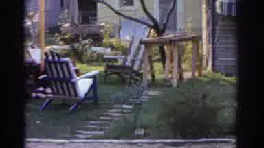 New Jersey USA (1963): Wooden Chairs And People Walk Through The Streets