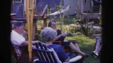 New Jersey USA (1963): Three Elder Women And Man Sitting In Chairs Outside House