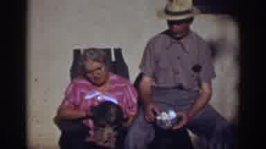 Auburn California-1939: Woman Holding And Then Throwing A Dog Sitting With A Man