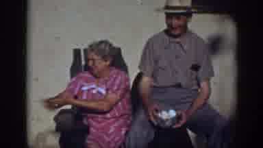Auburn California-1939: Older Couple Enjoying Time Watching And Feeding Their Chickens
