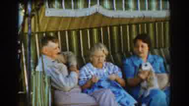 Auburn California (1939): Women Talking While One Of Them Have A Dog On Her Leg