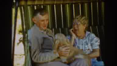Auburn California (1939): Elderly Couple Pets Tan Cocker Spaniel Dog While Sitting