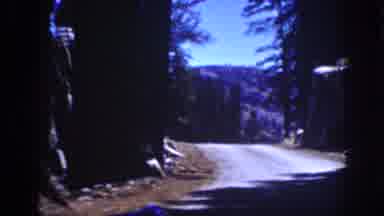 Lake Tahoe California (1939): A Vehicle Travels A Gravel Road Through A Forest