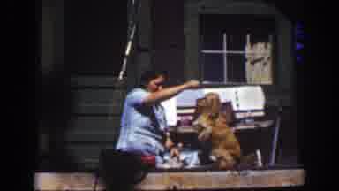 Lake Tahoe California (1939): Image Of Hut And A Woman Playing With A Dog
