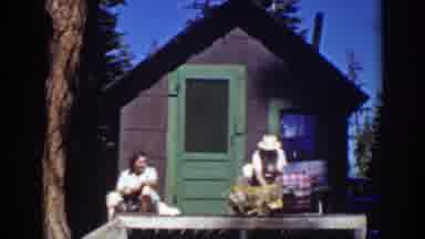 Lake Tahoe California (1939): Two People Outside Of A Tiny House With A Dog While
