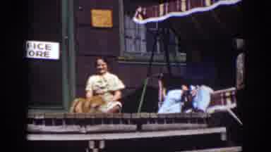 Lake Tahoe California (1939): A Woman And Man On A Porch Watching Two Other Men