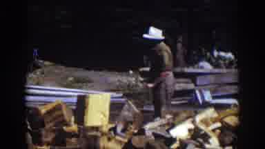 Lake Tahoe California (1939): Man Wearing White Hat Chops Wood With Ax On A Sunny