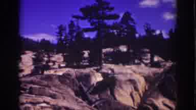 Lake Tahoe California (1939): View Of Brown Boulders Green Trees And Blue Sky On A