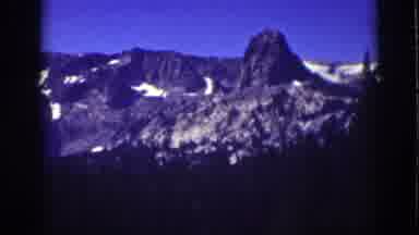 Lake Tahoe California (1939): A Beautiful View Of Some Mountain Through Some Pine
