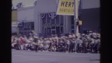 Norfolk Virginia (1966): White Car Tows Parade Float Down Street On A Sunny Day