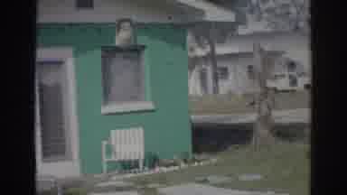 Norfolk Virginia (1966): Older Woman Walks Around Teal House As Camera Pans Around