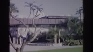 Norfolk Virginia (1966): An Elderly Couple Walk On A Building's Grass Yard As The