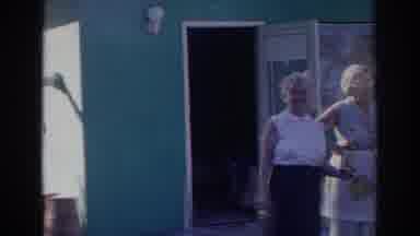 Norfolk Virginia (1966): Four People Stand In Front Of Green Building On A Sunny