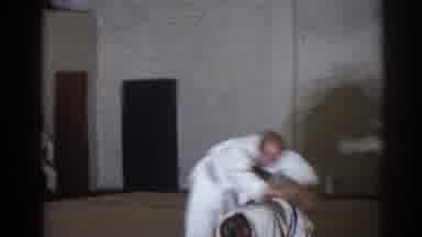 San Gabriel California (1966): Men Wearing White Karate Uniforms Leap Over Another