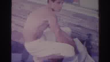 Temple City California (1966): A Young Kid Cleaning His White Shirt Close To A