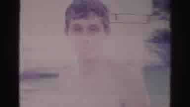 Temple City California (1966): Boy Walking Across Screen Tongue Out Shorts Street