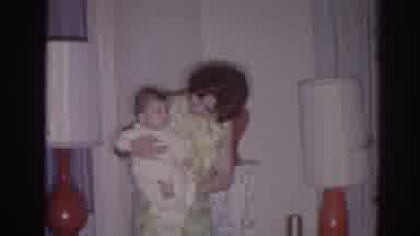 Temple City California (1966): A Mom Keeping Her Baby In The Arms And Smiling