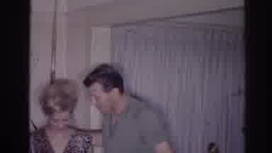 Temple City California (1966): Woman Wearing Green Dress Holds Baby Wrapped In