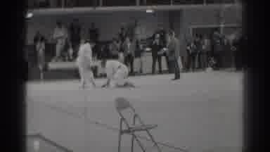 West Covina California (1966): Man Wearing Light Grey Shirt Talks With Men Wearing