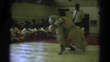 West Covina California (1966): Man Wearing White Shirt Watches Karate Skirmish In