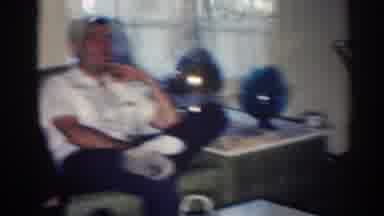 Los Angeles California (1967): Man Wearing Open White Shirt Sits Next To White