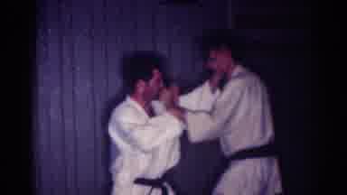 Los Angeles California (1967): Two Men Practicing Judo Fight Both Having Black