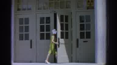 Los Angeles California (1967): Woman Yellow Dress White Hat Entering Large Stone