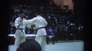 Los Angeles California (1967): Two Young Men Prepare To Practice Karate In A Large