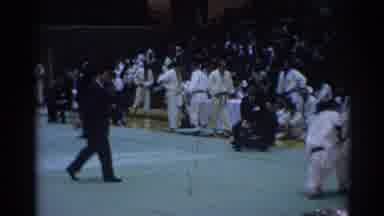 Los Angeles California (1967): Man Wearing Black Suit Watches Karate Match In