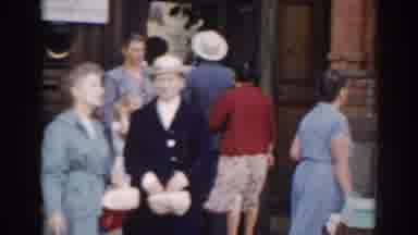 Moscow Russia (1968): Woman Wearing Grey Dress Walks Out Of Brown Building On A
