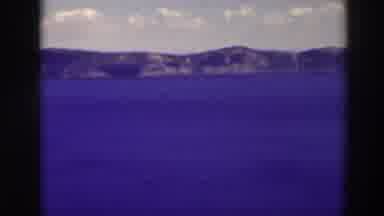 Crater Lake Oregon (1937): Panning Scene Of The Ocean With Mountains In The