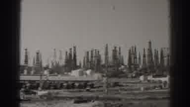 Long Beach California (1937): A Vehicle Drives Down A Road In Front Of A Forest Of
