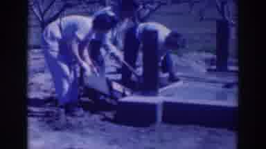 Sacramento California (1937): Woman Wearing White Pants Lifts Wooden Object From