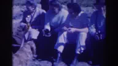 Sacramento California (1937): Women And Men Are Sitting And Talking On The Ground