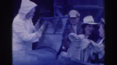 Sacramento California (1937): Person In A Rain Jacket And Gloves Places Their