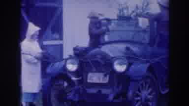 Sacramento California (1937): Two Men Clean The Glass On An Old Automobile While A