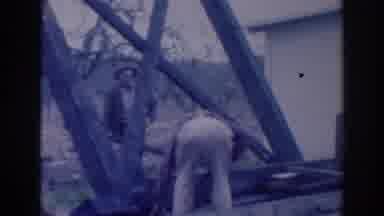 Sacramento California (1937): Person Wearing Grey Jacket Watches Man Wearing Tan