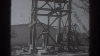 Sacramento California (1937): Man Places Two By Four Next To Wooden Tower On A