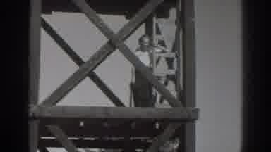 Sacramento California (1937): Woman Watches Man Climb Up A Ladder On A Scaffolding