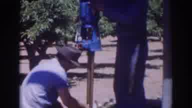 Sacramento California (1937): A Man Works On Fixing The Bottom Of A Pole Near