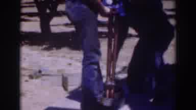 Sacramento California (1937): Two Men Inserting Blue Object Into Ground On A Sunny