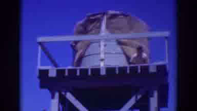 Sacramento California (1937): A Man Is Working At The Top Of A Water Tower He